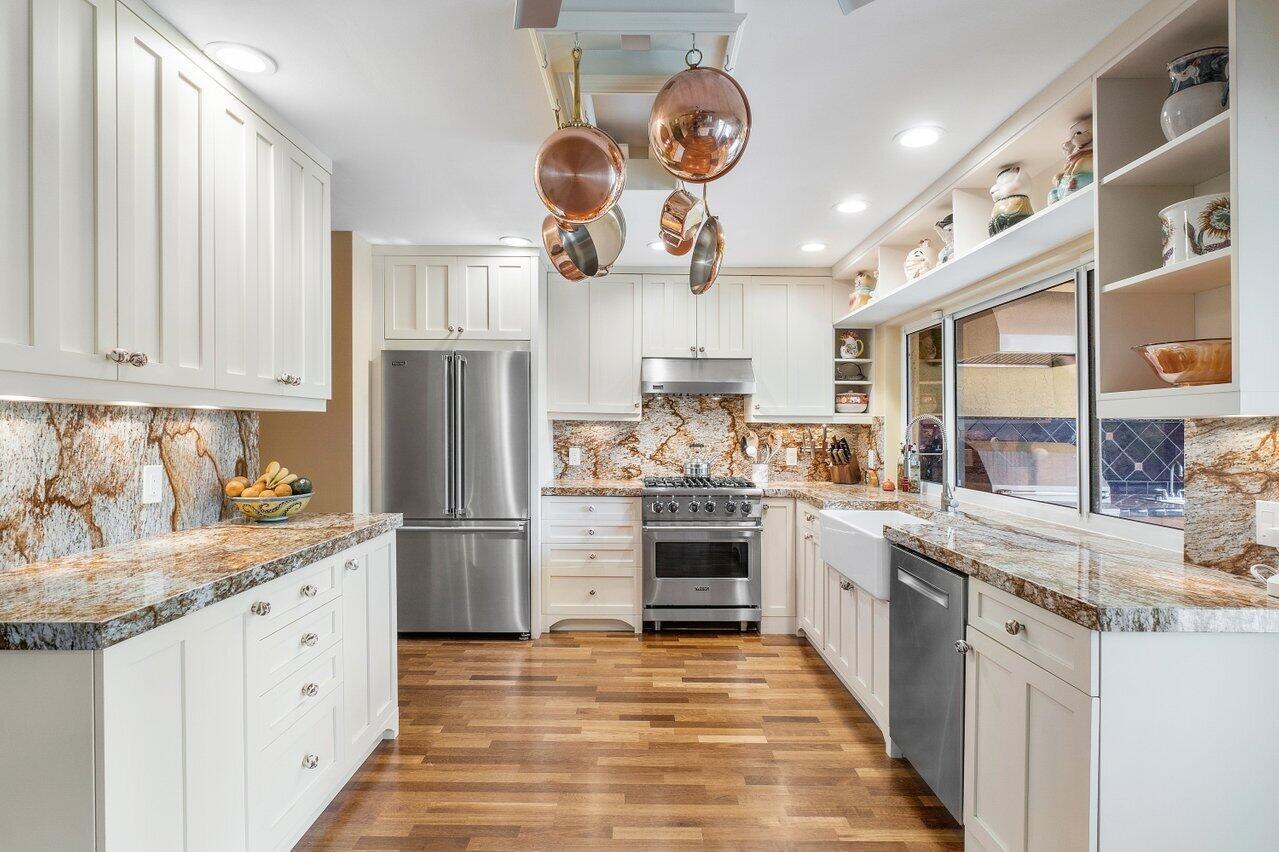 3484 Pine Haven Circle Boca Raton, FL 33431 - Photo 25 of 80 a kitchen with stainless steel appliances granite countertop a stove and a sink