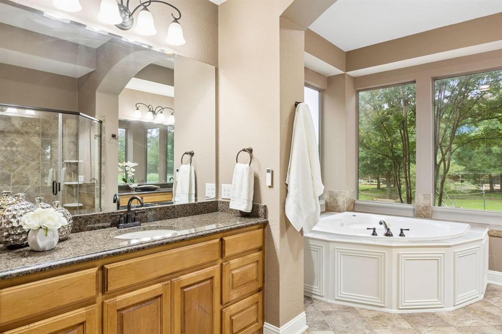 5802 Corinth Chapel Road Parker, TX 75002 - Photo 21 of 39 This bathroom is a dream! Oversized walk-inshower with updated surround, attachments &shelves as of 2024.(Window curtains are present, not shown in picture)