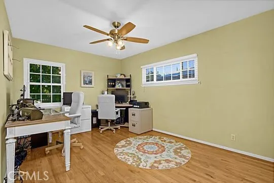 a view of a workspace with furniture and a window