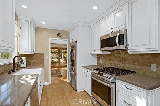 a kitchen with granite countertop a stove and a sink