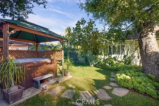 a view of a backyard with plants and patio
