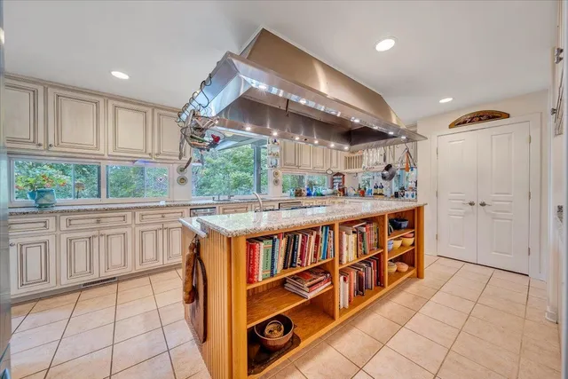 a view of a livingroom with a fireplace wooden floor and window