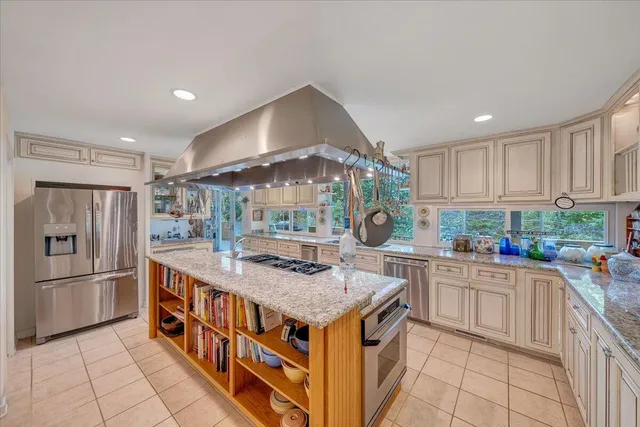 a spacious bathroom with a sink a large mirror and shower