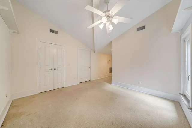 a view of a house with a yard and large tree