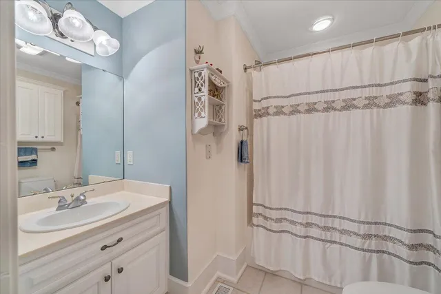a view of a house with a yard and potted plants