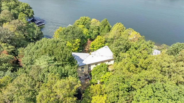 a living room with furniture and floor to ceiling window