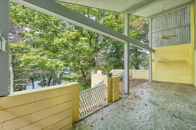 an aerial view of a house with a yard and lake view