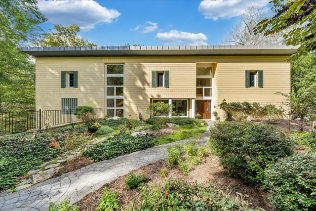 a living room with hard wood flooring and a book shelf