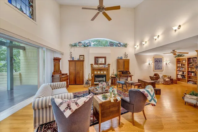 a living room with furniture a rug and a floor to ceiling window