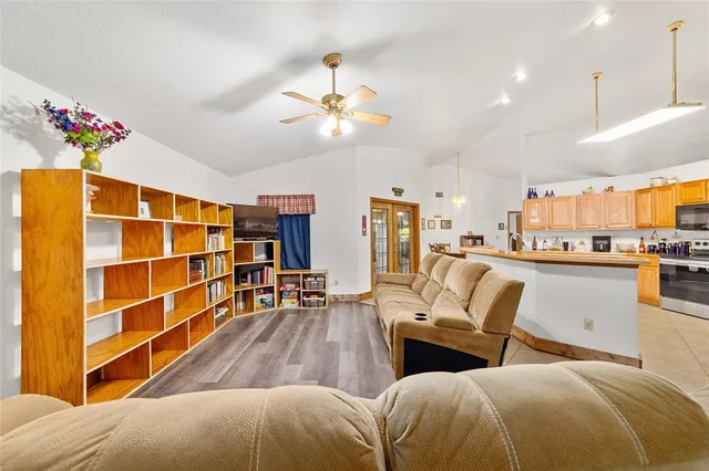 a living room with furniture and a baby crib