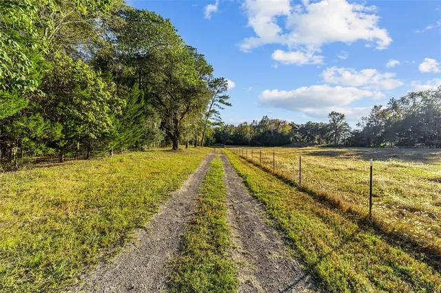 a spacious bathroom with a double vanity sink a mirror and a bathtub
