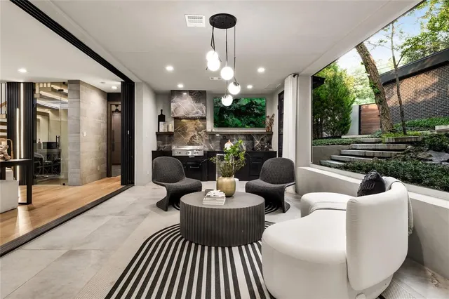 a living room with patio furniture and a large window