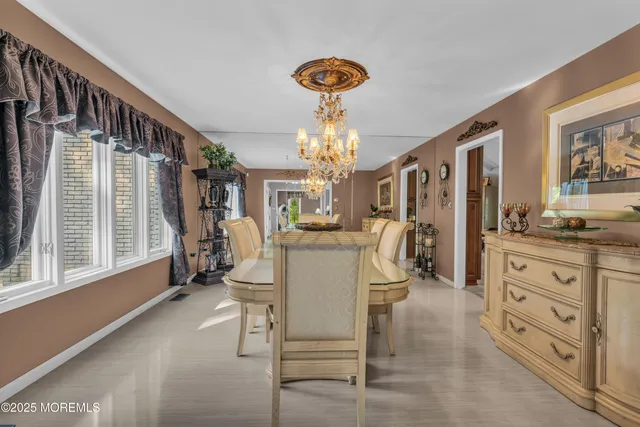 a kitchen with kitchen island granite countertop a stove top oven a sink a counter space and cabinets