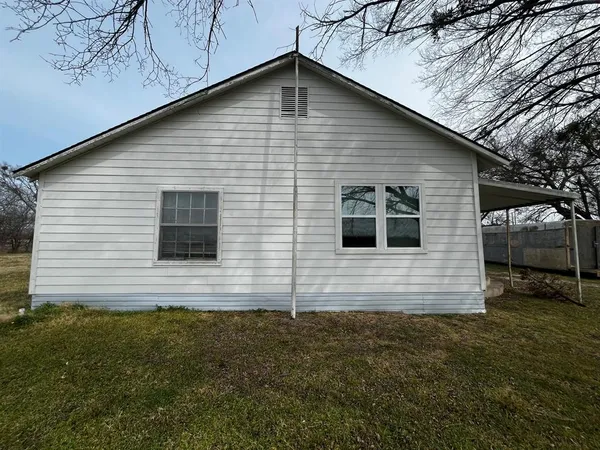 a view of house that has a yard