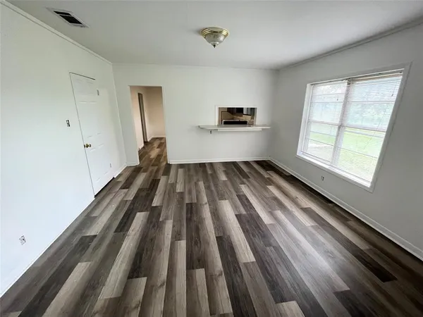 a view of an empty room and a window