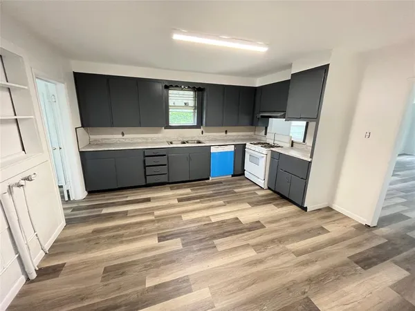 a view of kitchen with sink oven and window