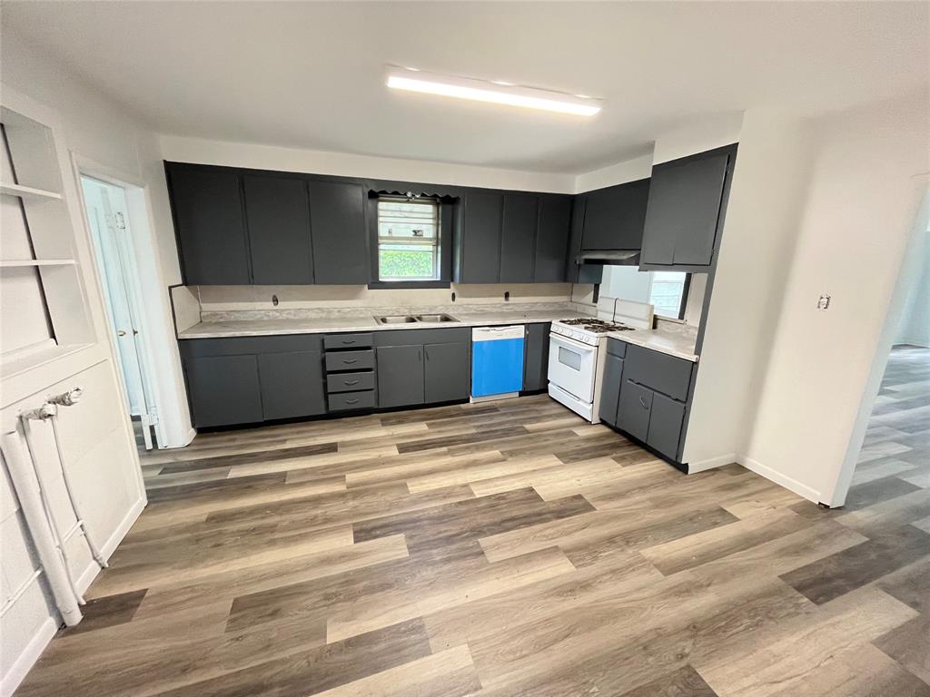 3619 FM 1183 Road Ennis, TX 75119 - Photo 5 of 12 Kitchen with dark cabinets and light color countertops.