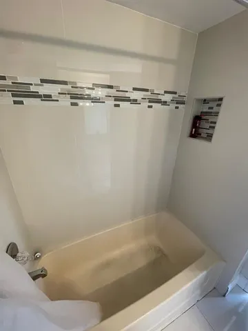 a bath tub sitting next to a sink