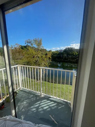 a view of balcony with wooden floor and fence
