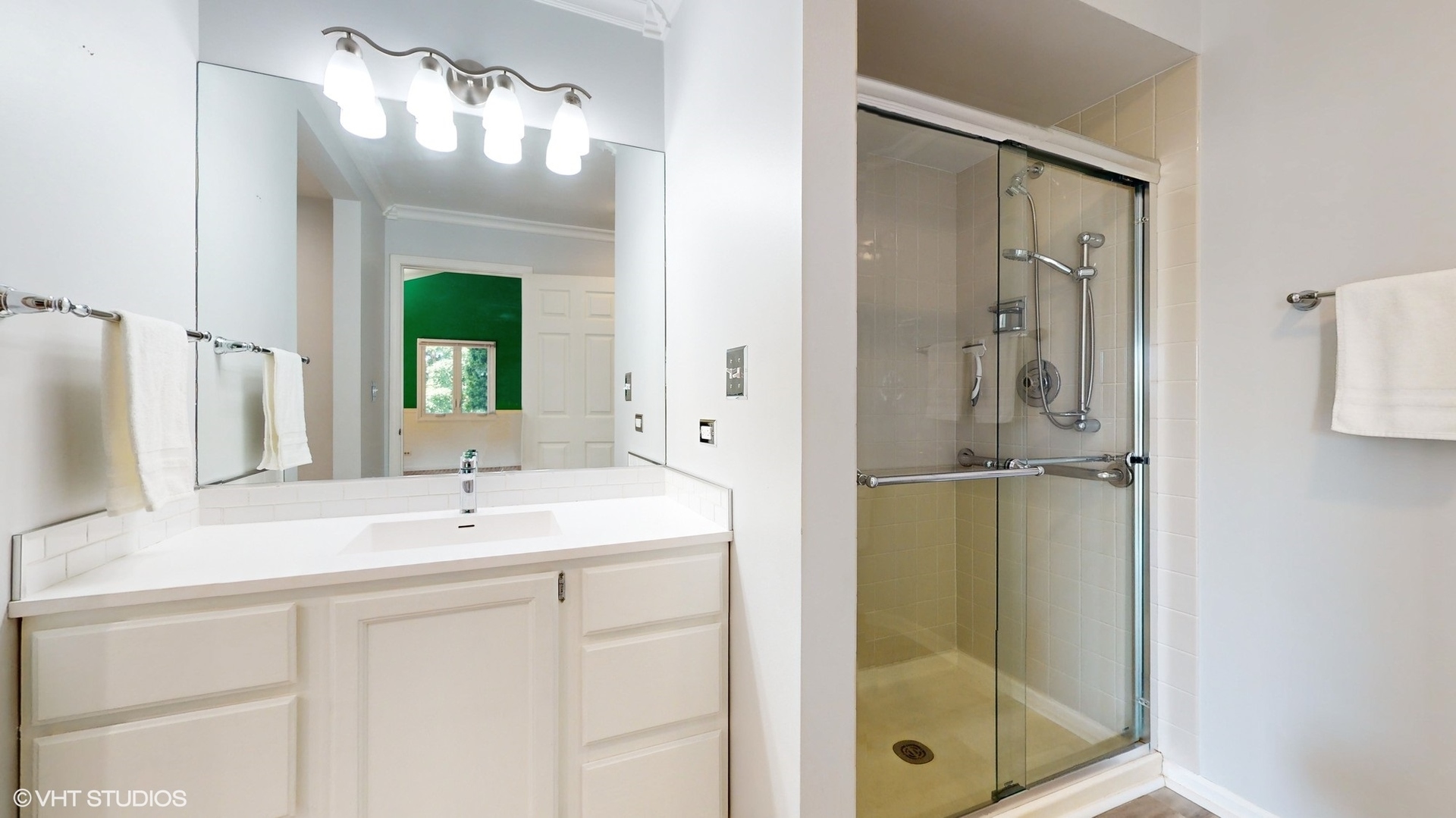 1857 Golfview Drive Bartlett, IL 60103 - Photo 2 of 26 a bathroom with a shower sink and mirror