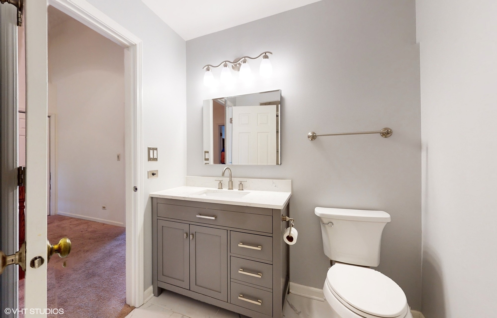 1857 Golfview Drive Bartlett, IL 60103 - Photo 7 of 26 a bathroom with a toilet a sink and mirror