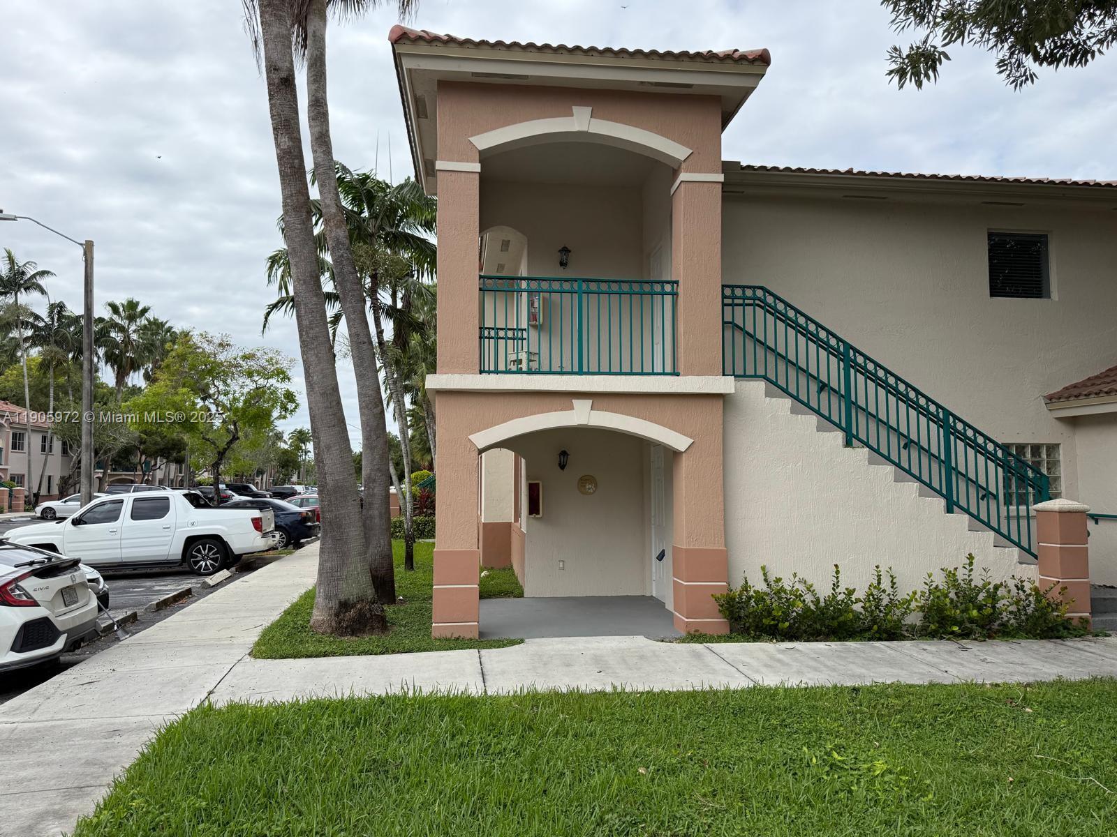 1261 Southeast 31st Court, Unit 10653 Homestead, FL 33035 - Photo 1 of 10 a front view of a house with a garden and trees