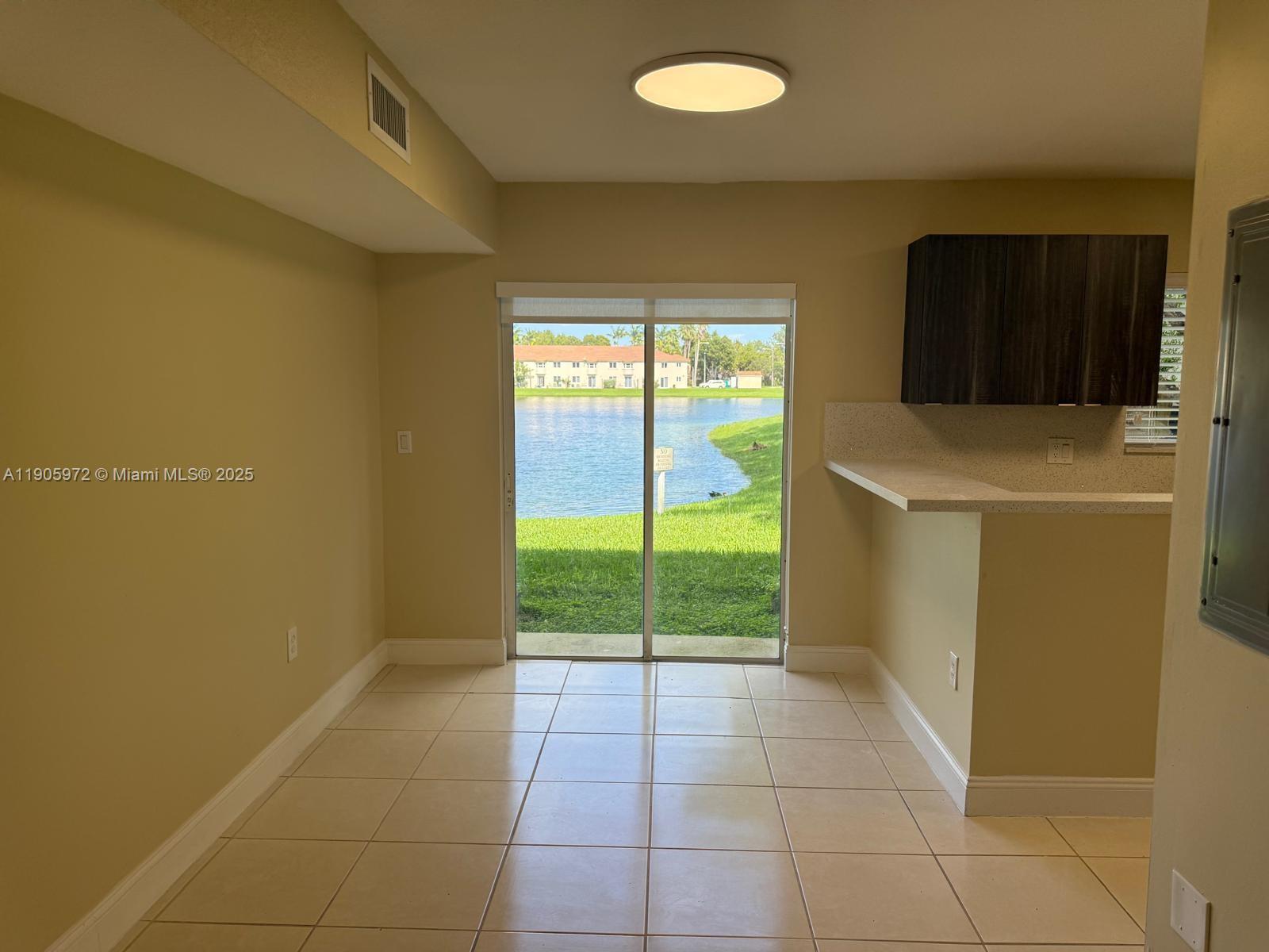 1261 Southeast 31st Court, Unit 10653 Homestead, FL 33035 - Photo 3 of 10 a view of an empty room with a window