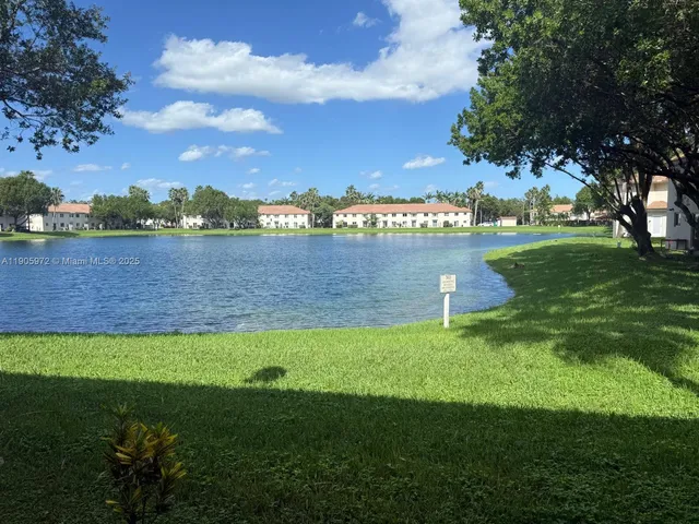 a view of a lake with houses in the back