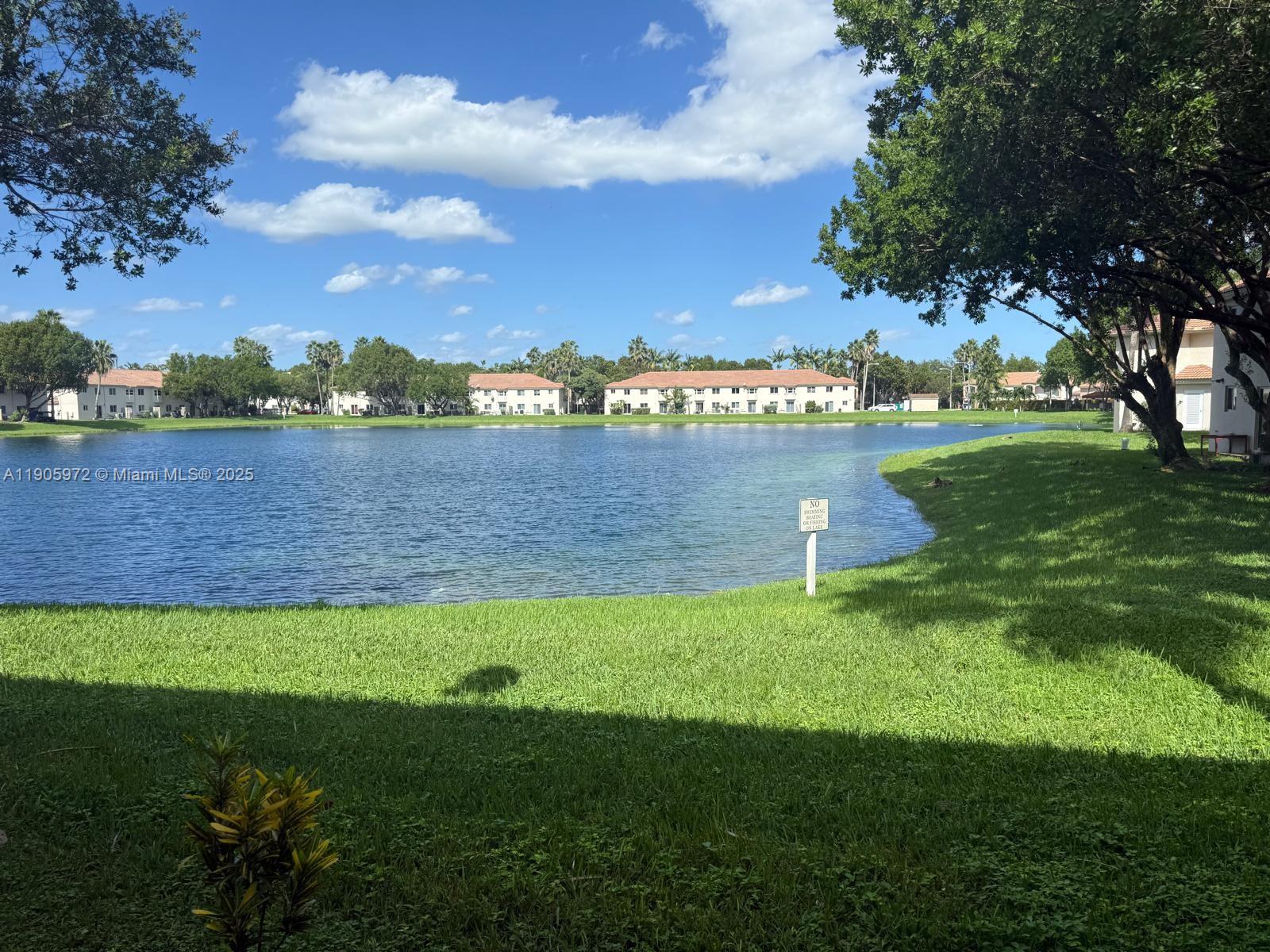 1261 Southeast 31st Court, Unit 10653 Homestead, FL 33035 - Photo 8 of 10 a view of a lake with houses in the back