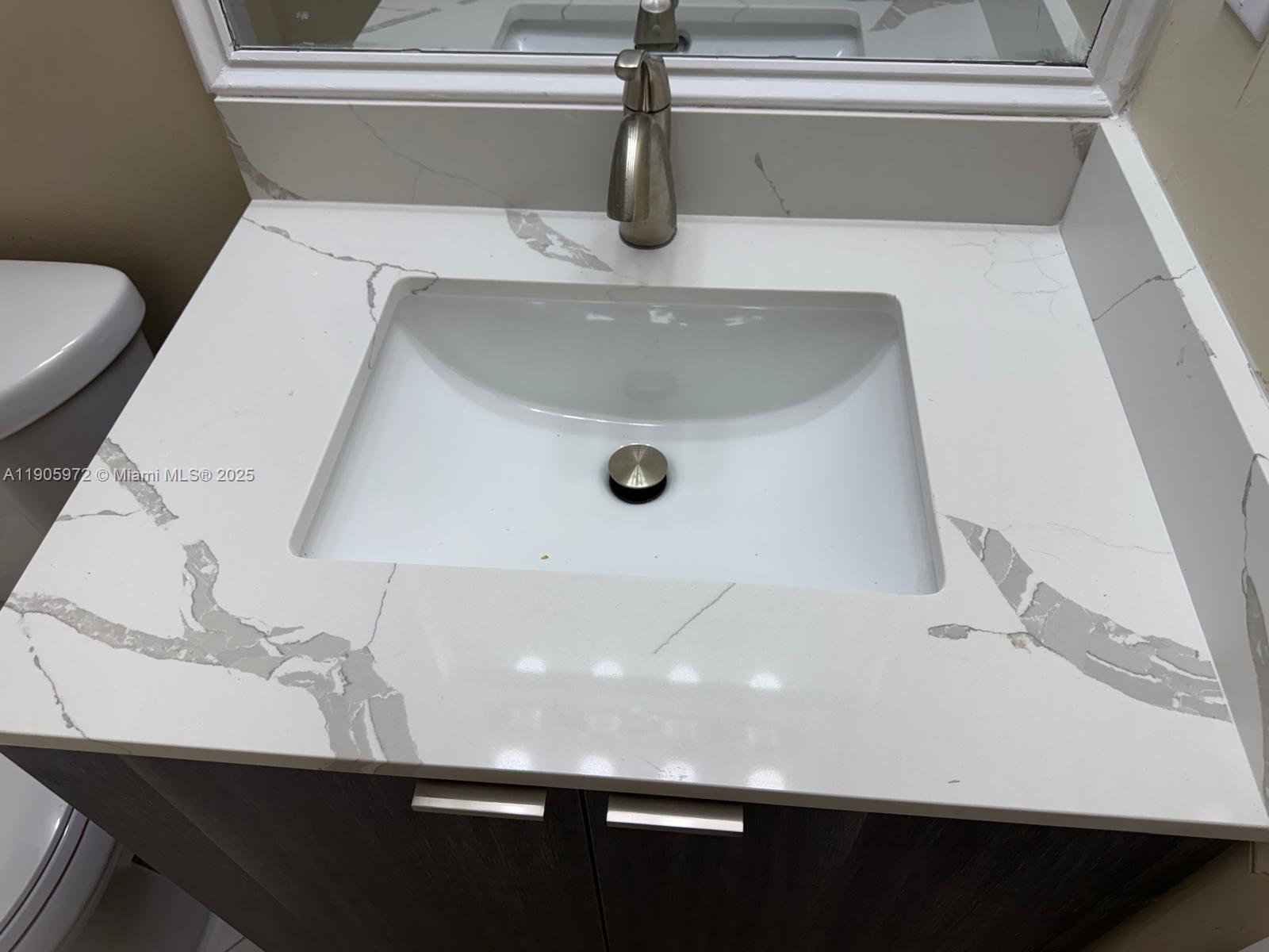 1261 Southeast 31st Court, Unit 10653 Homestead, FL 33035 - Photo 10 of 10 a bathroom with a sink and toilet