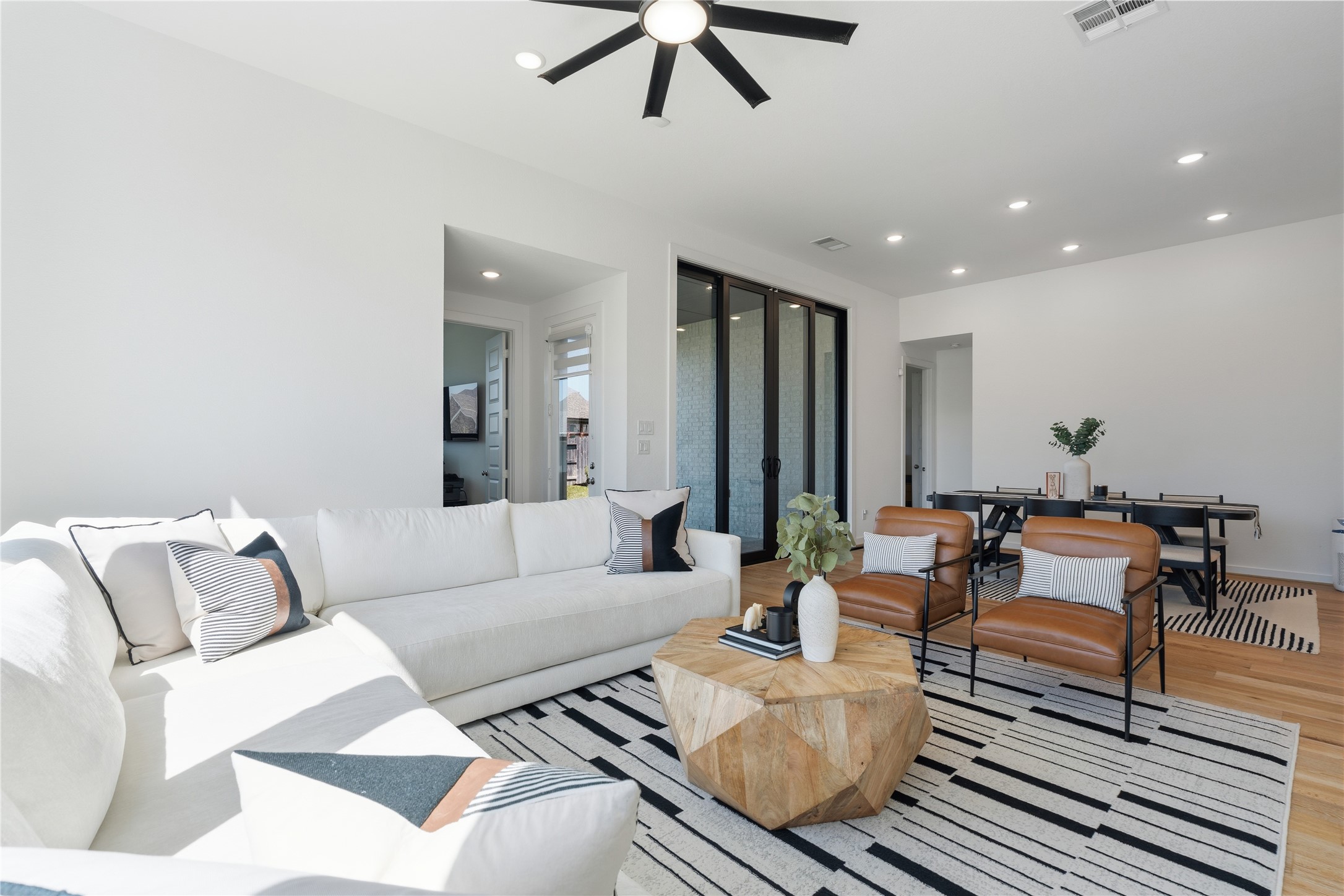416 Bartlett Street Webster, TX 77598 - Photo 20 of 49 Living room with sectional, leather chairs, and abundant natural light