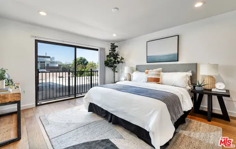 a spacious bedroom with a bed and a large window