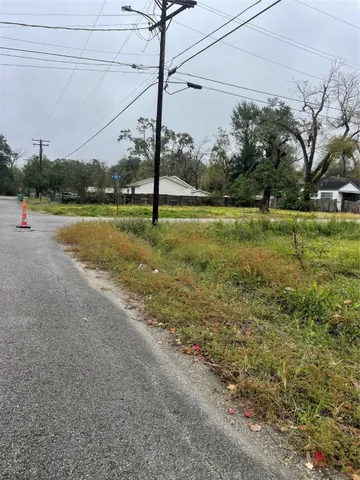 a view of swimming pool with a yard and large trees