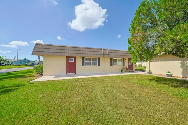 a front view of house with yard and outdoor seating