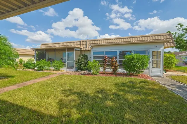 a front view of house with yard and green space