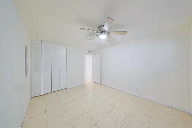a bathroom with a granite countertop toilet sink and mirror
