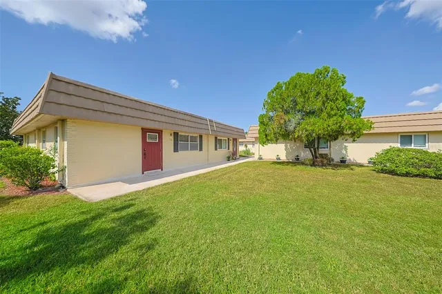 a front view of house with yard and trees