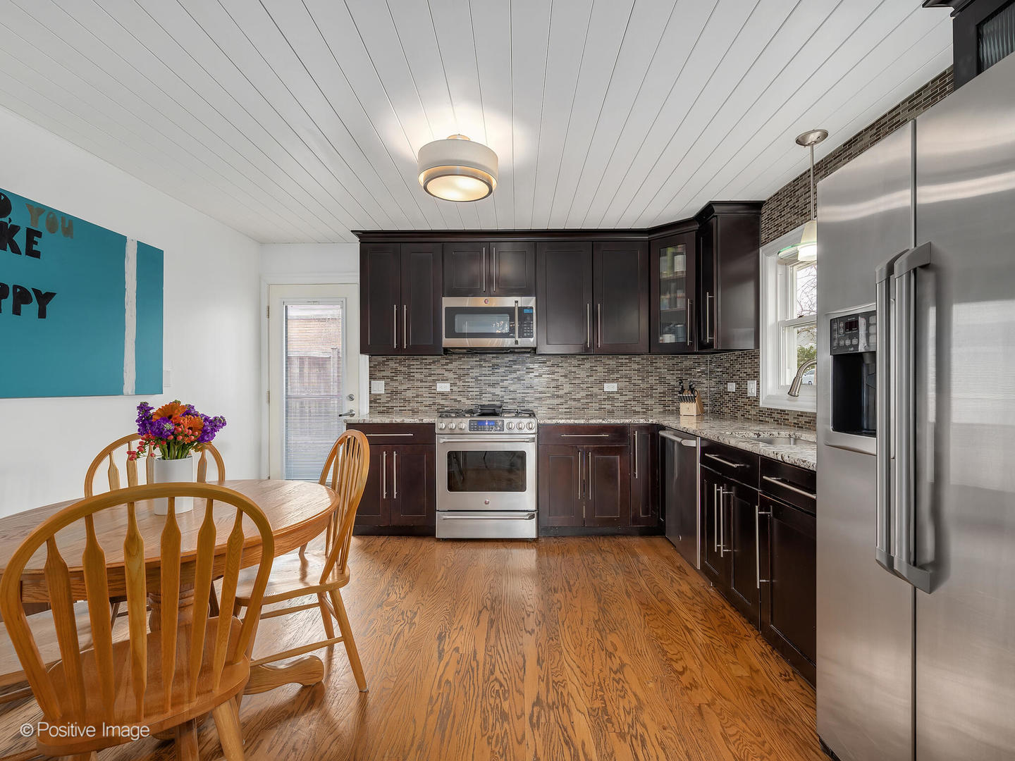 319 Maple Street Glen Ellyn, IL 60137 - Photo 8 of 26 a kitchen with stainless steel appliances granite countertop a stove top oven a sink dishwasher a dining table and chairs