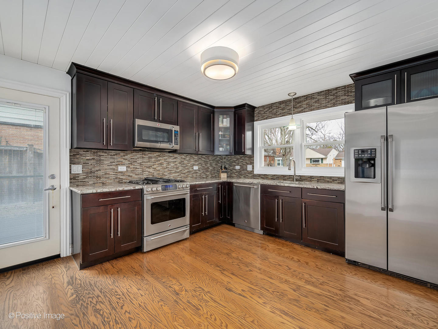 319 Maple Street Glen Ellyn, IL 60137 - Photo 9 of 26 a kitchen with granite countertop stainless steel appliances and wooden cabinets