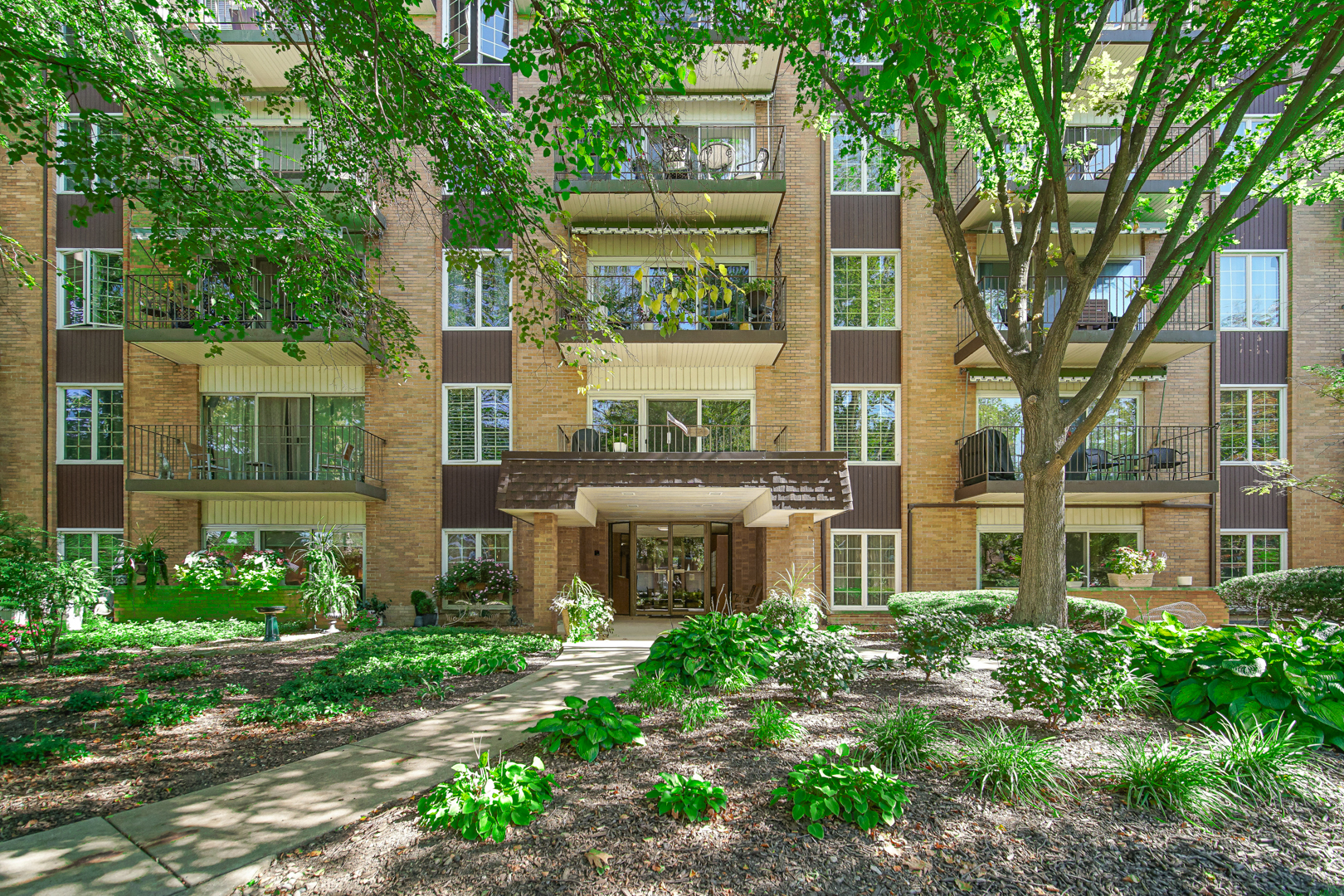 445 North Park Boulevard, Unit 3F Glen Ellyn, IL 60137 - Photo 1 of 20 front view of a building with a garden