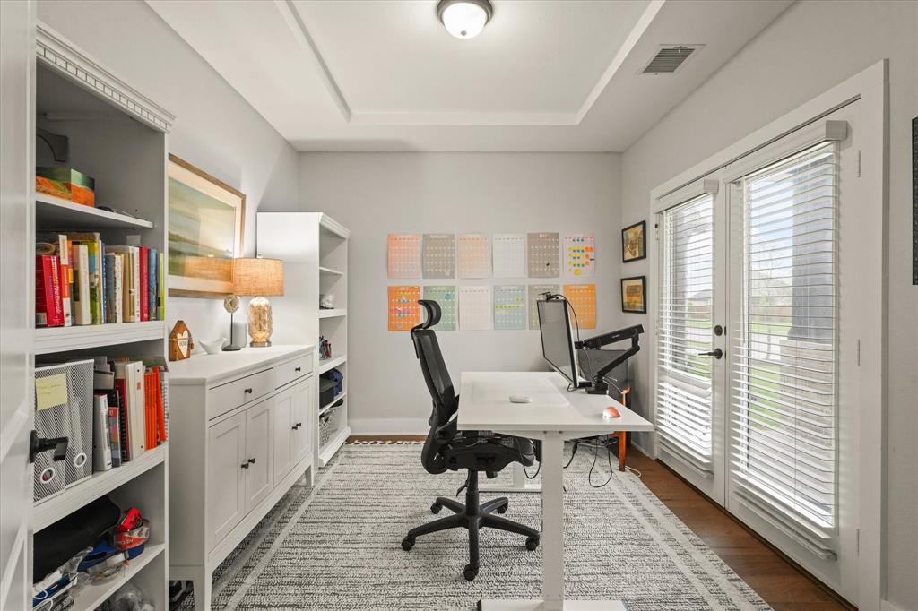 1714 Highwood Road Forney, TX 75126 - Photo 7 of 30 Tray ceiling with recessed lighting, wood-finish flooring, and white built-in shelving