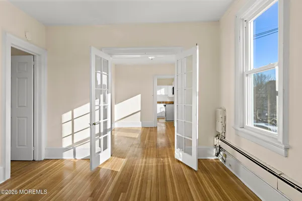 a view of a room with wooden floor and a window