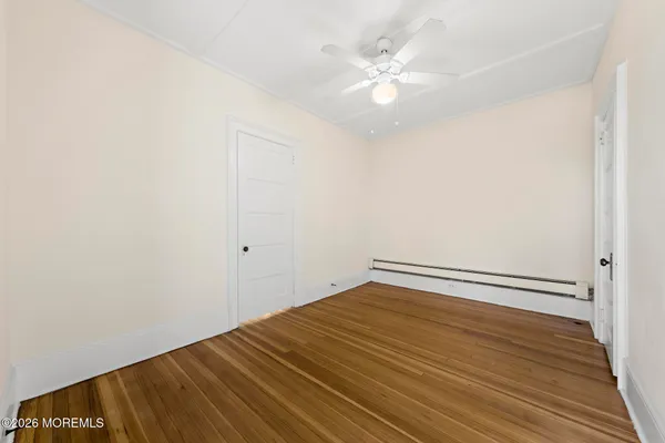 a view of a room with wooden floor