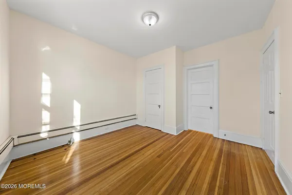 a view of a room with wooden floor