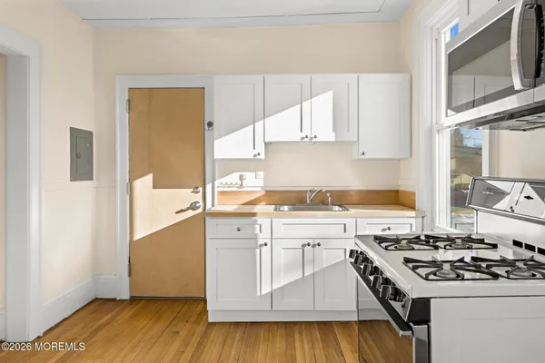 a kitchen with a stove a sink and a refrigerator