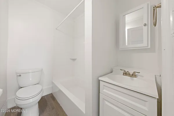 a white toilet sitting next to a bathroom sink