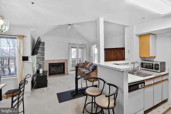 a living room with furniture a fireplace and flat screen tv
