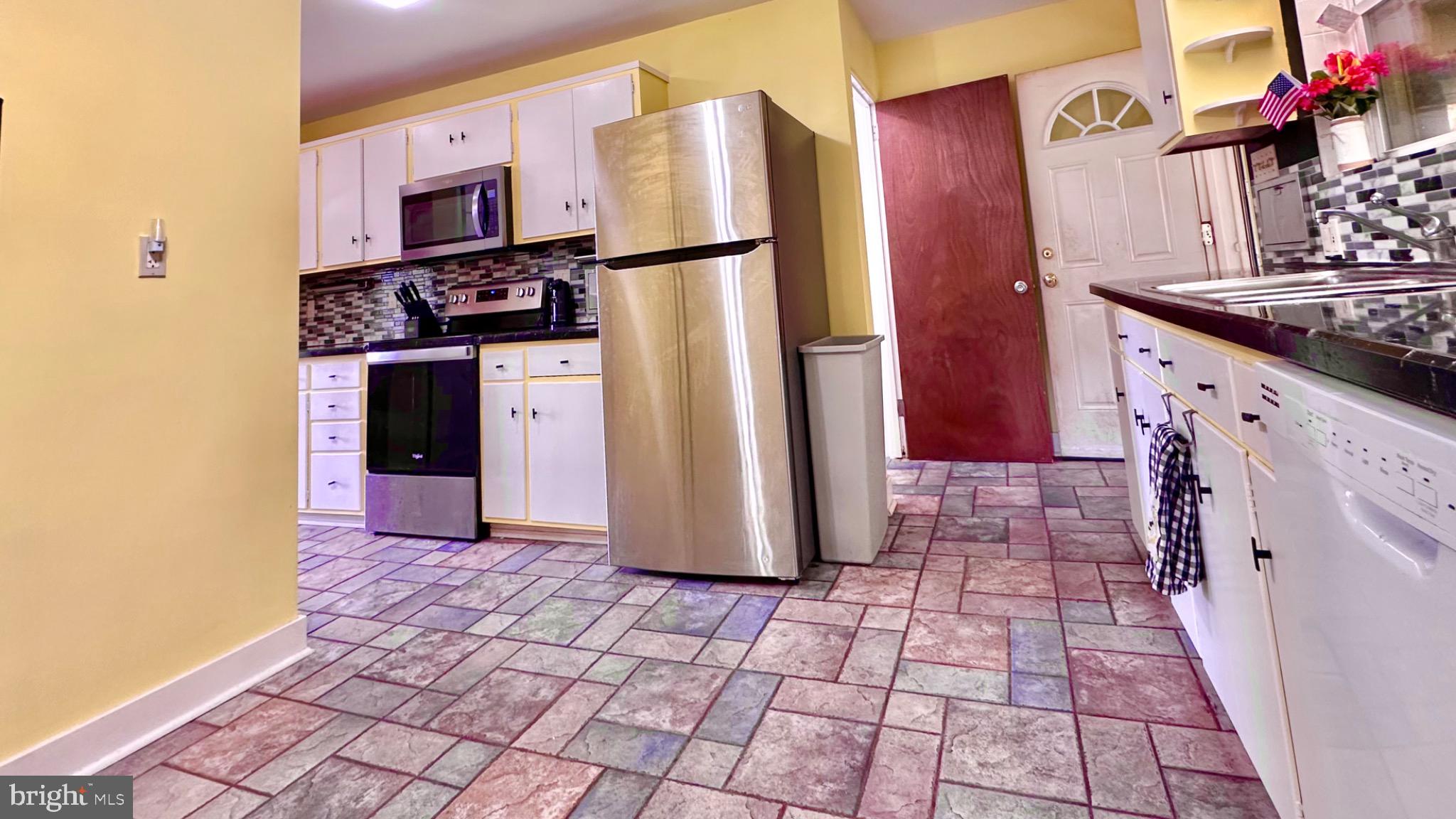 98 Maple Street Macungie, PA 18062 - Photo 11 of 56 a kitchen with stainless steel appliances granite countertop a refrigerator and a stove