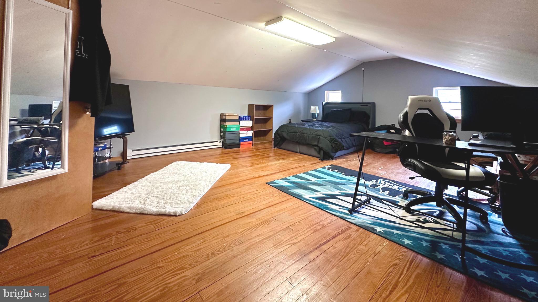 98 Maple Street Macungie, PA 18062 - Photo 38 of 56 a living room with furniture a flat screen tv and a wooden floor