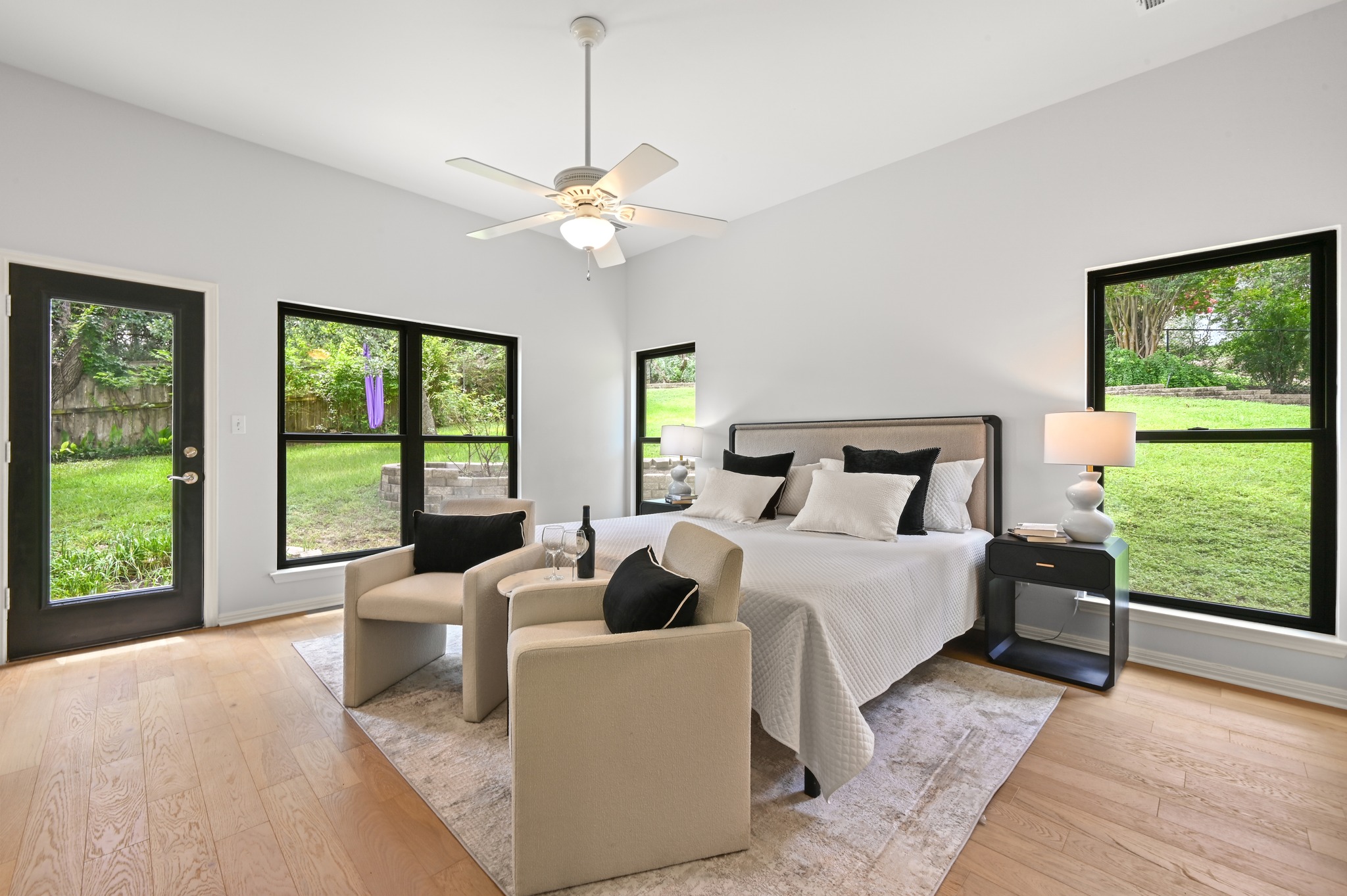 1107 Bowie Road Austin, TX 78733 - Photo 20 of 40 Natural light floods this spacious primary suite, offering serene views of the surrounding greenery.